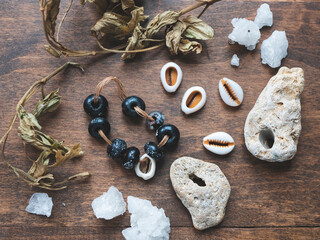 Secret or mysterious ingredients: talisman, dry herbs, cowrie shells, crystals and rare stones with holes. Spirit or pagan rituals