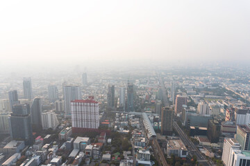 Landscape of the top view Bangkok metropolis Thailand with the light dirty clouds air pollution problem. the tower and building in business area