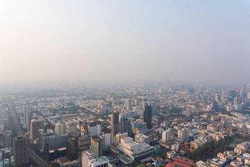 Fototapeta na wymiar Landscape of the top view Bangkok metropolis Thailand with the dirty clouds air pollution problem. The tower and building in business area downtown