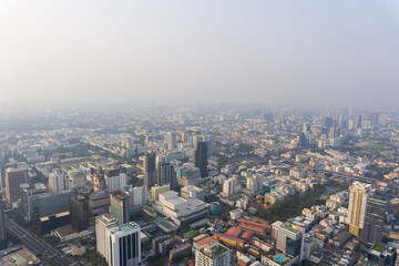 Fototapeta premium Landscape of the top view Bangkok metropolis Thailand with the dirty clouds air pollution problem. the tower and building in business centre area