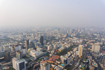 Fototapeta na wymiar Landscape of the wide top view Bangkok metropolis Thailand with the dirty clouds air pollution problem. the tower and building in business area