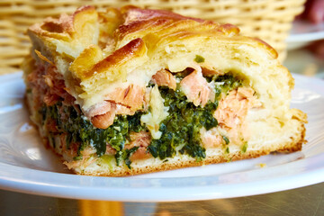 Pie with red fish and spinach close-up