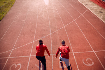 Two young men are racing at an athletic training at the stadium. Sport, athletics, athletes