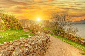 Urquhart Castle at sunset beside Loch Ness in Scotland, United Kingdom. Close to Drumnadrochit village. It is one of the most visited castles for the legend of the Loch Ness monster.