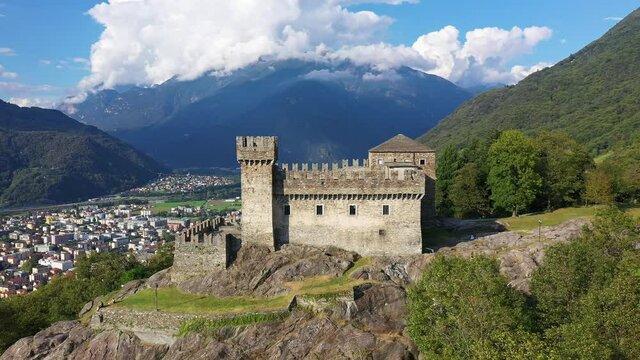 Aerial drone footage of the Sasso Corbaro castle overlooking the Bellinzona city in canton Ticino in Switzerland. Shot with a rotation motion. 
