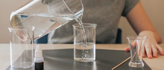 Teenage girl filling a glass with water. Banner.