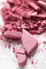 Cosmetic texture background. Broken eye shadows. Pink magenta decorative cosmetics 