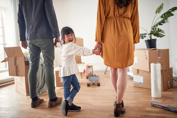 Joyful multi ethnic family moving in together; New beginning concept