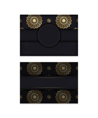 Black greeting card with mandala gold pattern prepared for typography.