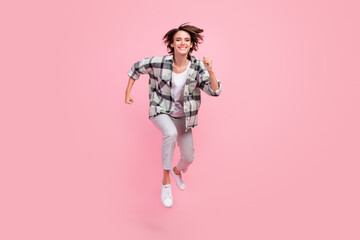 Full length photo of funny young brunette lady run wear shirt trousers isolated on pink background