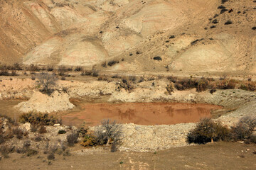 Red reservoir in the red mountains. Khizi region. Azerbaijan.