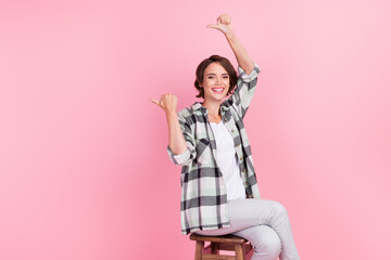 Photo of sweet millennial brunette lady point empty space wear shirt trousers isolated on pink background