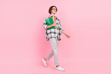 Fototapeta premium Full size profile side photo of young woman happy positive smile go walk notebook study isolated over pink color background