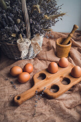 Brown chicken eggs on a wooden stand
