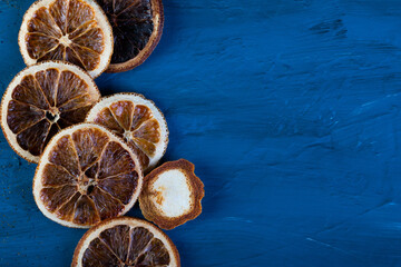 dried oranges on a dark blue slate, stone or concrete background.Christmas background, celebration, New Year's party concept. Beautiful jewelry. ingredients for making mulled wine. top view