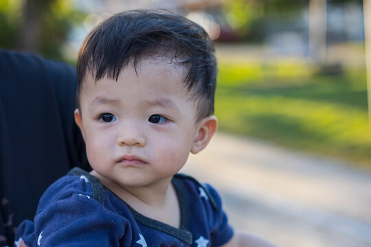 portrait image of Happy and cute Asian Chinese baby boy at park during evening