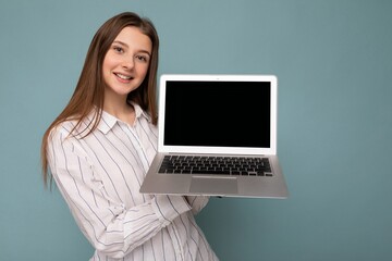 Close-up portrait of Beautiful young woman holding netbook computer looking at camera