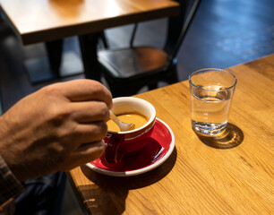 Man stirring sugar in coffee