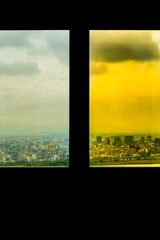 two separate views  with different colors of the  city from the same  window frame