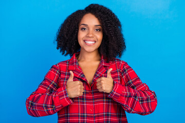 Photo of cool young brunette lady thumb up wear red checkered pajama isolated on blue color background