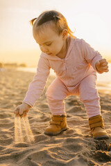 a girl play on the beach in the golden hour