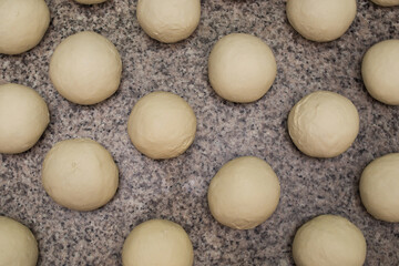 Dough. Bread dough. Fresh raw dough preparation. There are many round dough cookies on the table