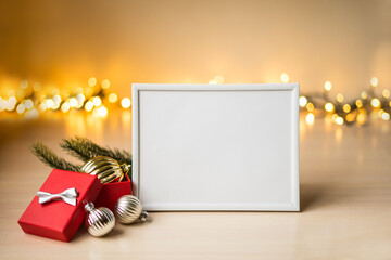 Portrait white picture frame mockup on table with boken lights and christmas decoration
