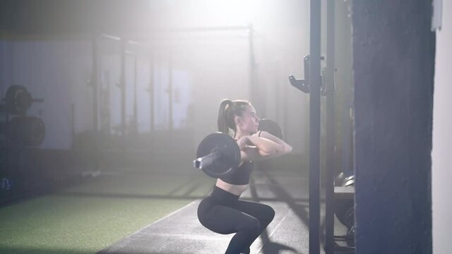 Woman front squat with barbell fitness weightlifting 4K