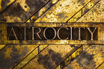 Atrocity text on textured grunge copper and vintage gold background