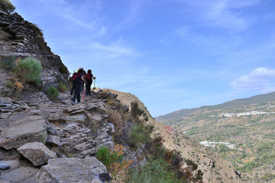 hikers going up the scarf of Fondales de La Taha in the Alpujarra