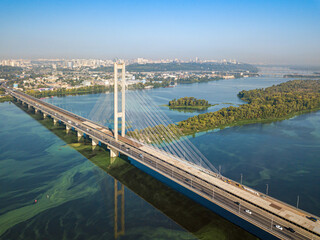 South bridge in Kiev. Algae bloom in the water of the Dnieper River. Aerial drone view.