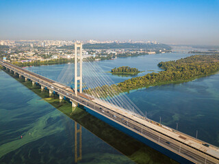 Fototapeta na wymiar South bridge in Kiev. Algae bloom in the water of the Dnieper River. Aerial drone view.