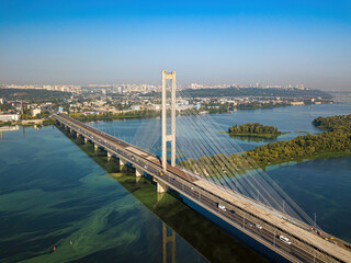 South bridge in Kiev. Algae bloom in the water of the Dnieper River. Aerial drone view.