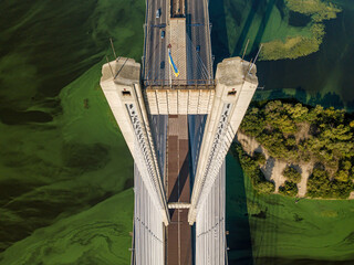 South bridge in Kiev. Algae bloom in the water of the Dnieper River. Aerial drone view.