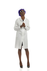 Happy black woman in a white lab coat is standing with holding hands and looking up. Full length, isolated. - 459084771