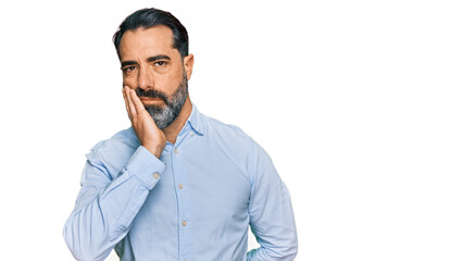 Middle aged man with beard wearing business shirt thinking looking tired and bored with depression problems with crossed arms.