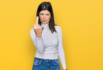 Beautiful brunette woman wearing casual clothes showing middle finger, impolite and rude fuck off...