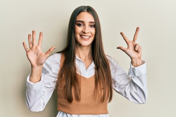 Beautiful brunette young woman wearing casual clothes showing and pointing up with fingers number eight while smiling confident and happy.