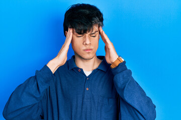 Fototapeta na wymiar Handsome hipster young man stranding over blue background suffering from headache desperate and stressed because pain and migraine. hands on head.