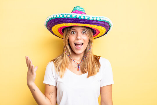 pretty blonde girl feeling happy, surprised realizing a solution or idea. mexican hat concept