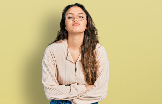 Young hispanic girl wearing casual clothes and glasses depressed and worry for distress, crying angry and afraid. sad expression.