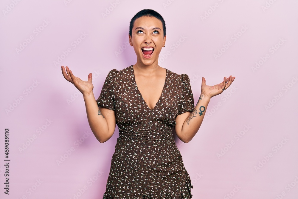 Poster beautiful hispanic woman with short hair wearing summer dress crazy and mad shouting and yelling wit