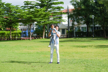 Happy asian family together with daughter in playground