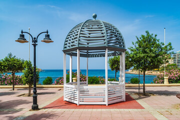 Street light and a gazebo on the promenade in Exiles, Malta..