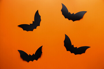 Bats on an orange background. Happy Halloween