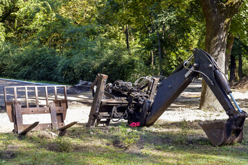 Attachments to small tractor. Loading forks. Bucket of small excavator. Strong teeth are ready to...