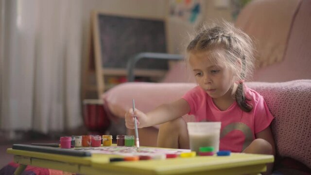 Little Girl Drawing With Paint Brush Sitting Floor Home Room Child Drawing Water color 4-5 Years Caucasian Female Stay Home