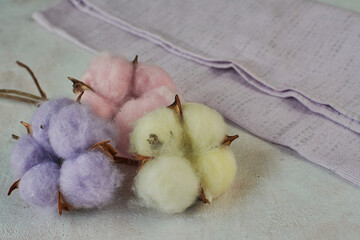 multicolored cotton bolls  on a wooden background.