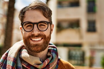 Young caucasian man with beard wearing glasses outdoors on a sunny day