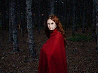 Naklejka premium woman in forest with red plaid travel posing